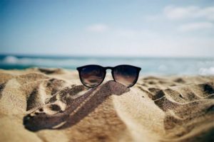 sunglasses in the sand on the beach